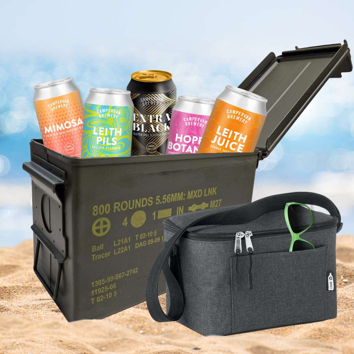beer gift set sitting on sand with beers popping out the top